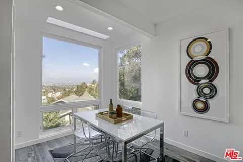 a view of a workspace with furniture and window