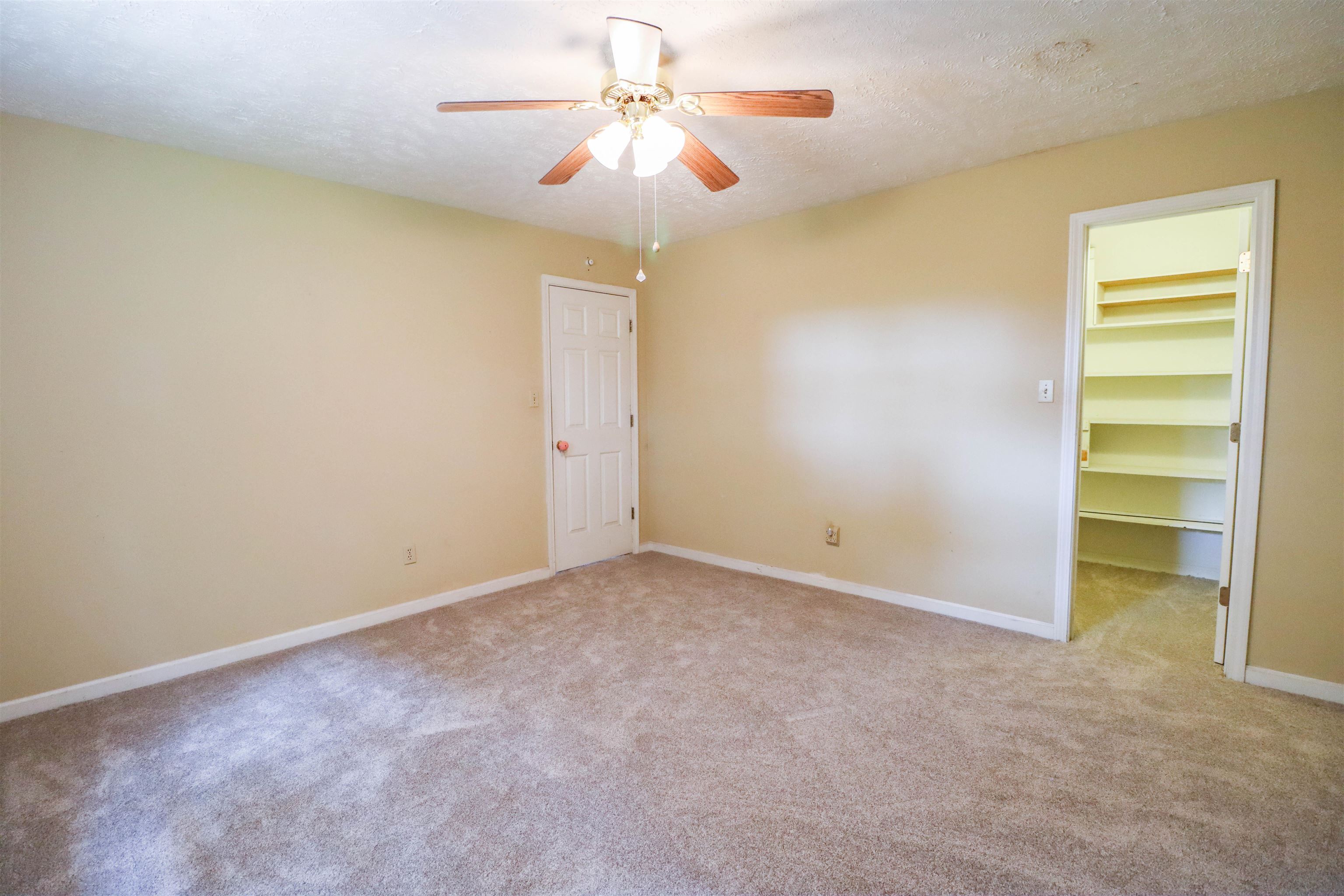 319 Jordan Street Ripley, TN 38063 - Photo 13 of 33 an empty room with a ceiling fan and a window