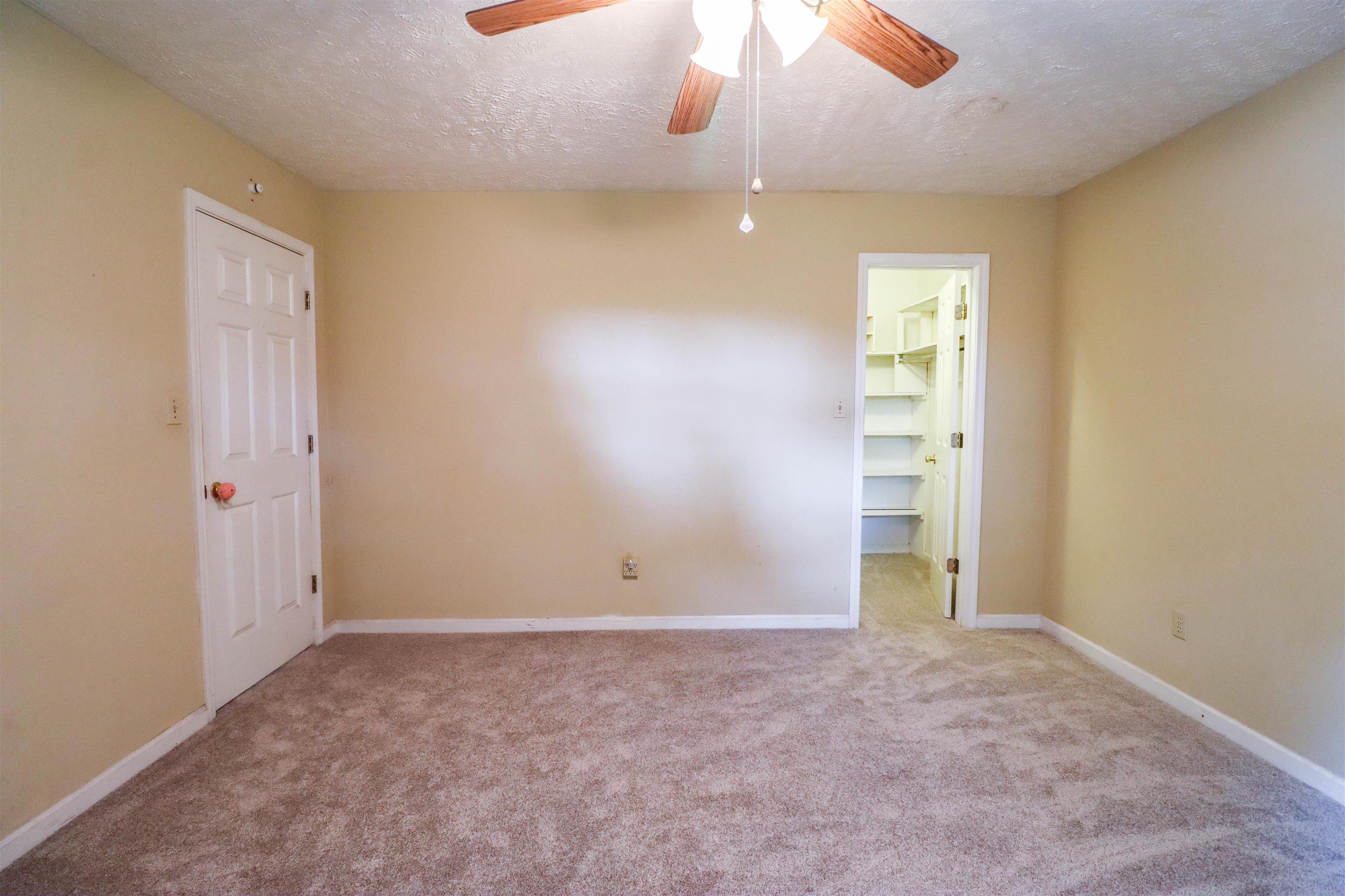 319 Jordan Street Ripley, TN 38063 - Photo 14 of 33 an empty room with a ceiling fan and window