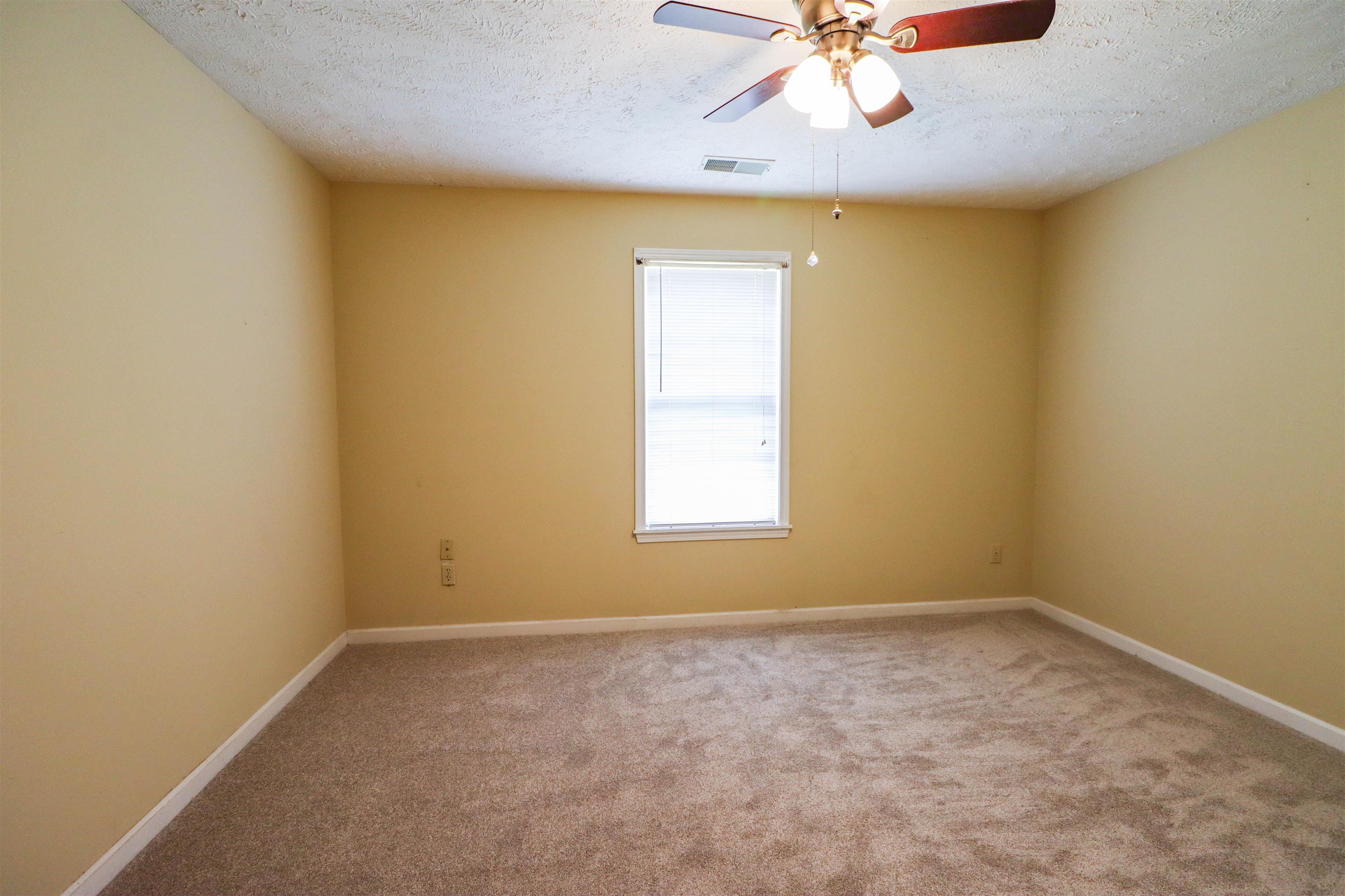 319 Jordan Street Ripley, TN 38063 - Photo 18 of 33 an empty room with a window and a ceiling fan