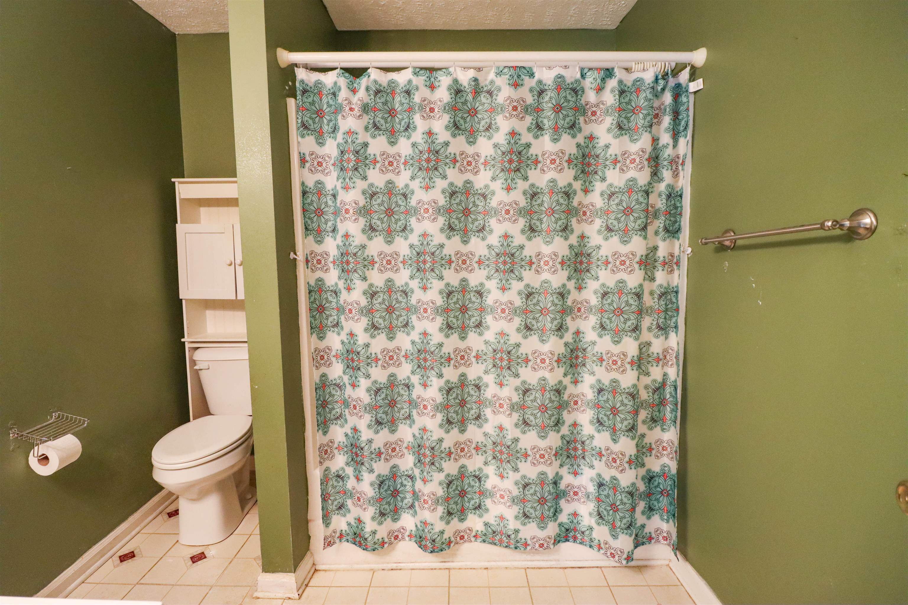 319 Jordan Street Ripley, TN 38063 - Photo 22 of 33 a bathroom with a toilet and a shower curtain