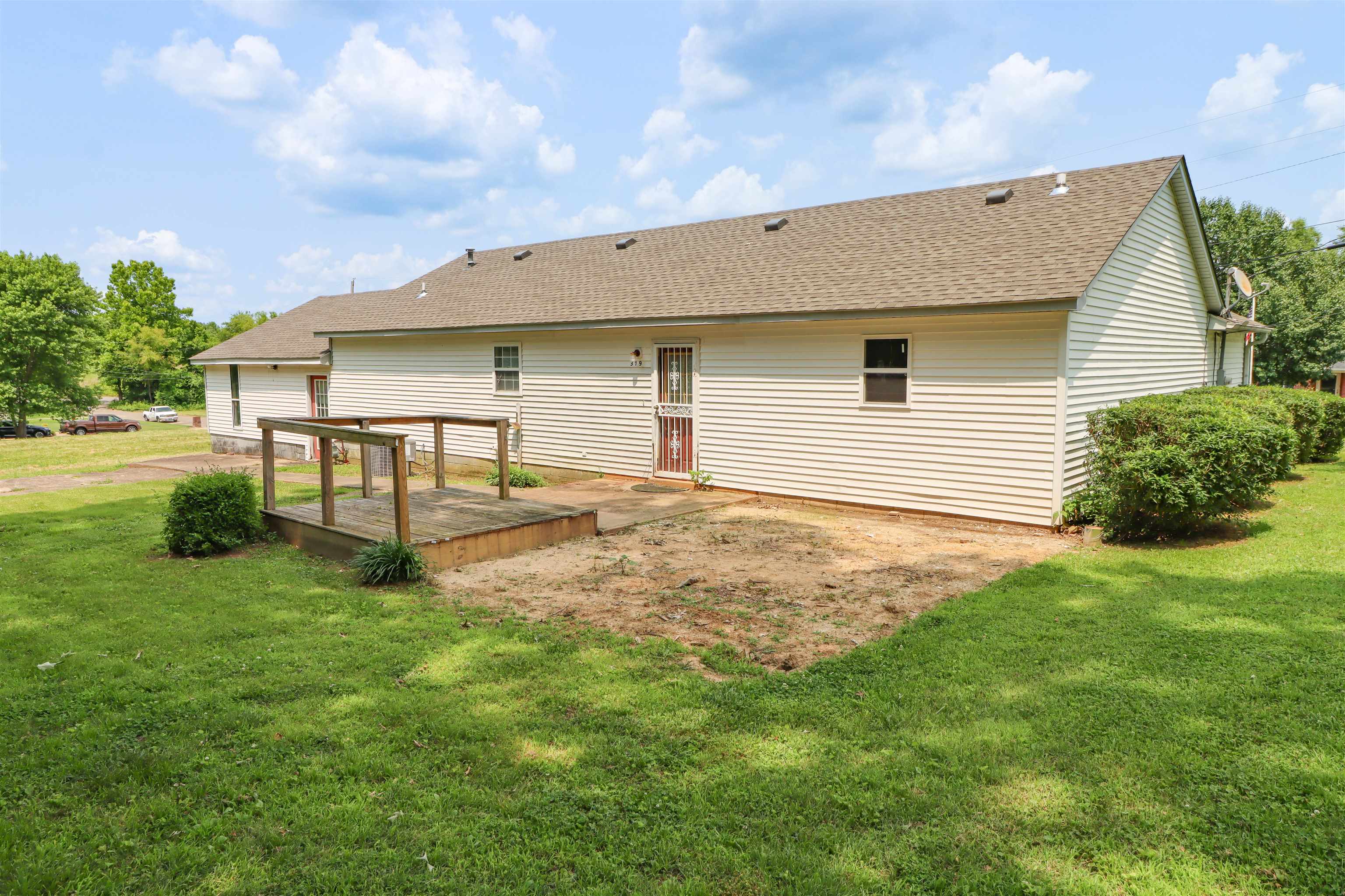 319 Jordan Street Ripley, TN 38063 - Photo 24 of 33 a backyard of a house with table and chairs