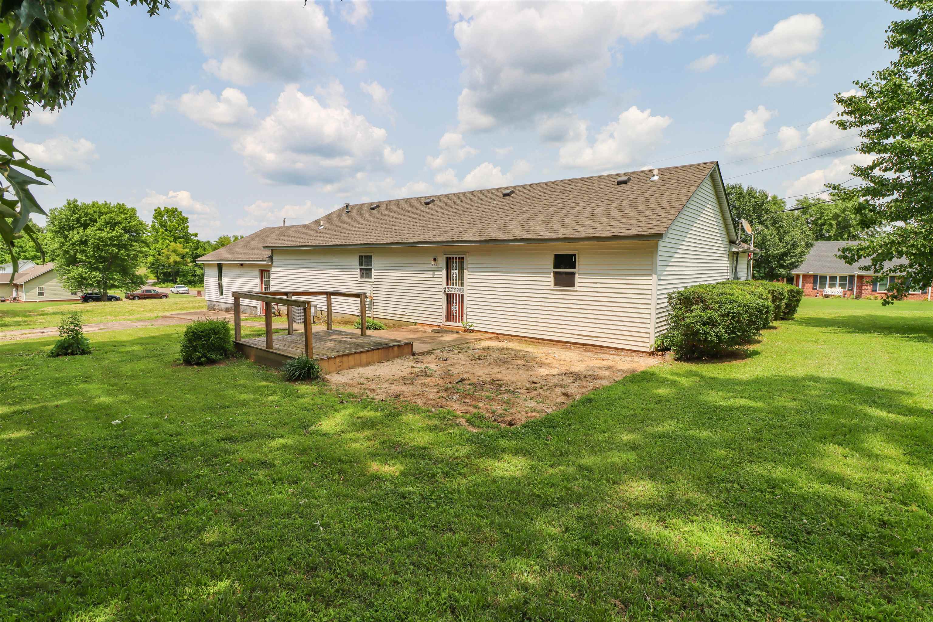319 Jordan Street Ripley, TN 38063 - Photo 25 of 33 a view of a house with a backyard