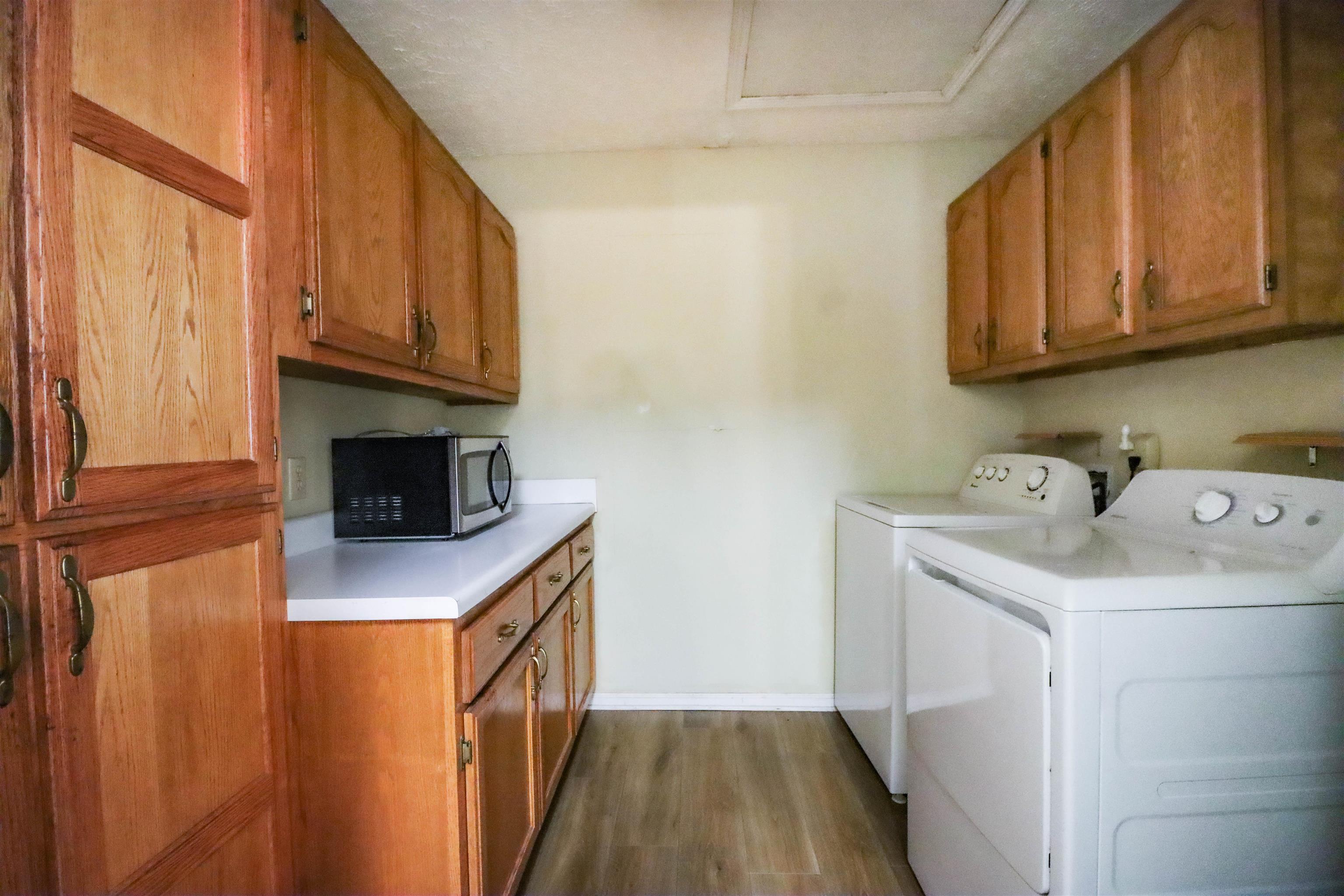 319 Jordan Street Ripley, TN 38063 - Photo 8 of 33 a kitchen with stainless steel appliances a sink a stove a microwave a sink and cabinets