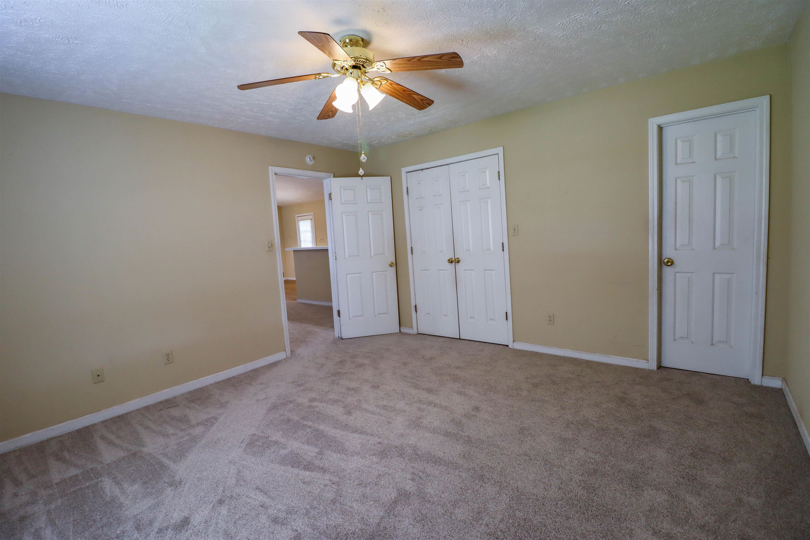 319 Jordan Street Ripley, TN 38063 - Photo 10 of 33 an empty room with closet and a chandelier fan