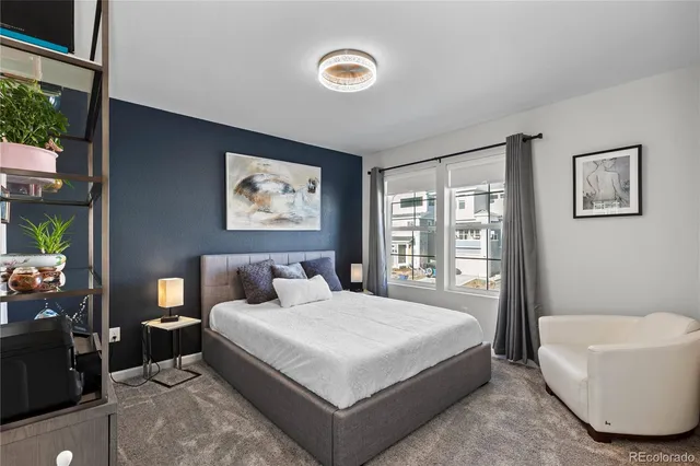 a spacious bedroom with a bed and a large window