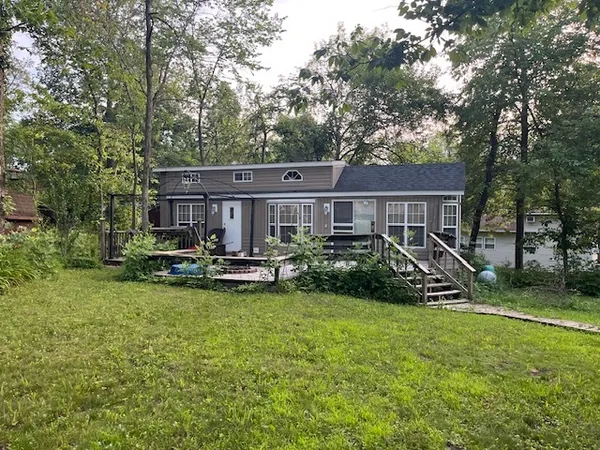 a view of a house with backyard porch and sitting area
