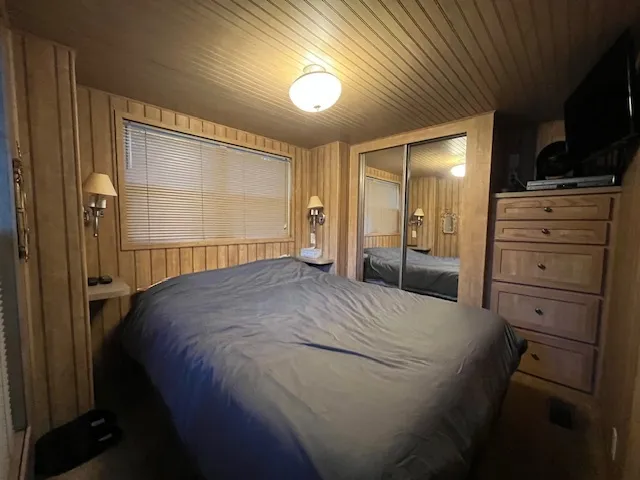 a bedroom with a bed and a flat tv screen