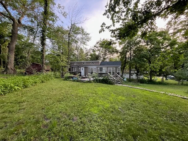 a view of a house with backyard and sitting area