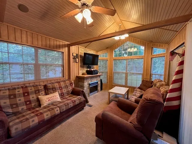 a living room with furniture a flat screen tv and a window