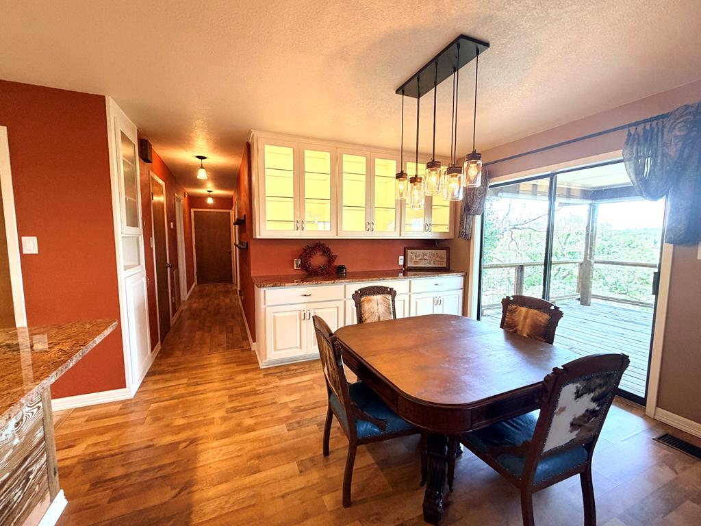 707 Rimrock Road Kerrville, TX 78028 - Photo 22 of 55 a view of a dining room with furniture window and outside view