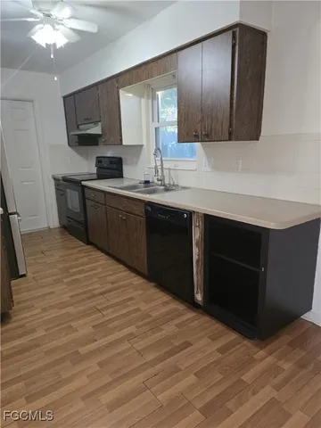 a kitchen with stainless steel appliances granite countertop a sink dishwasher stove and cabinets