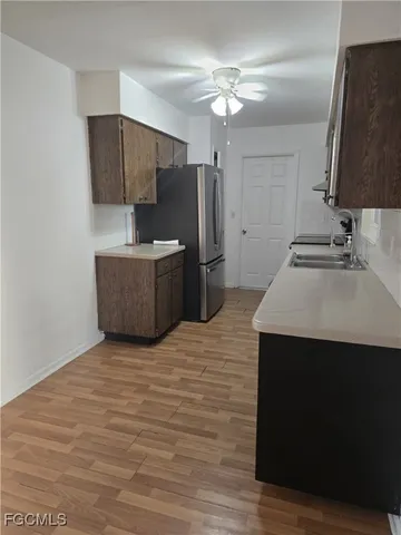 a kitchen with stainless steel appliances a sink stove and refrigerator