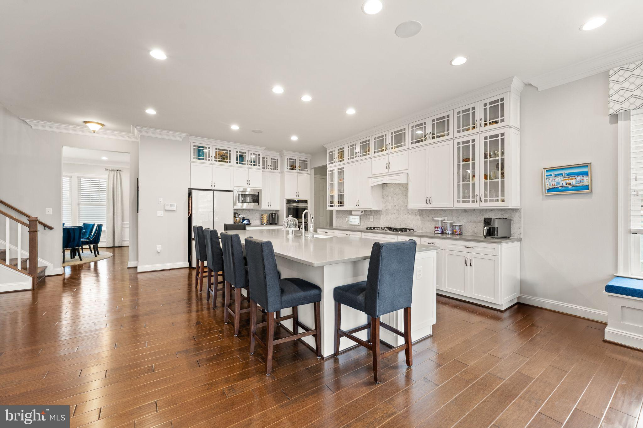 41865 Paddock Gate Place Ashburn, VA 20148 - Photo 11 of 99 a large kitchen with a table and chairs