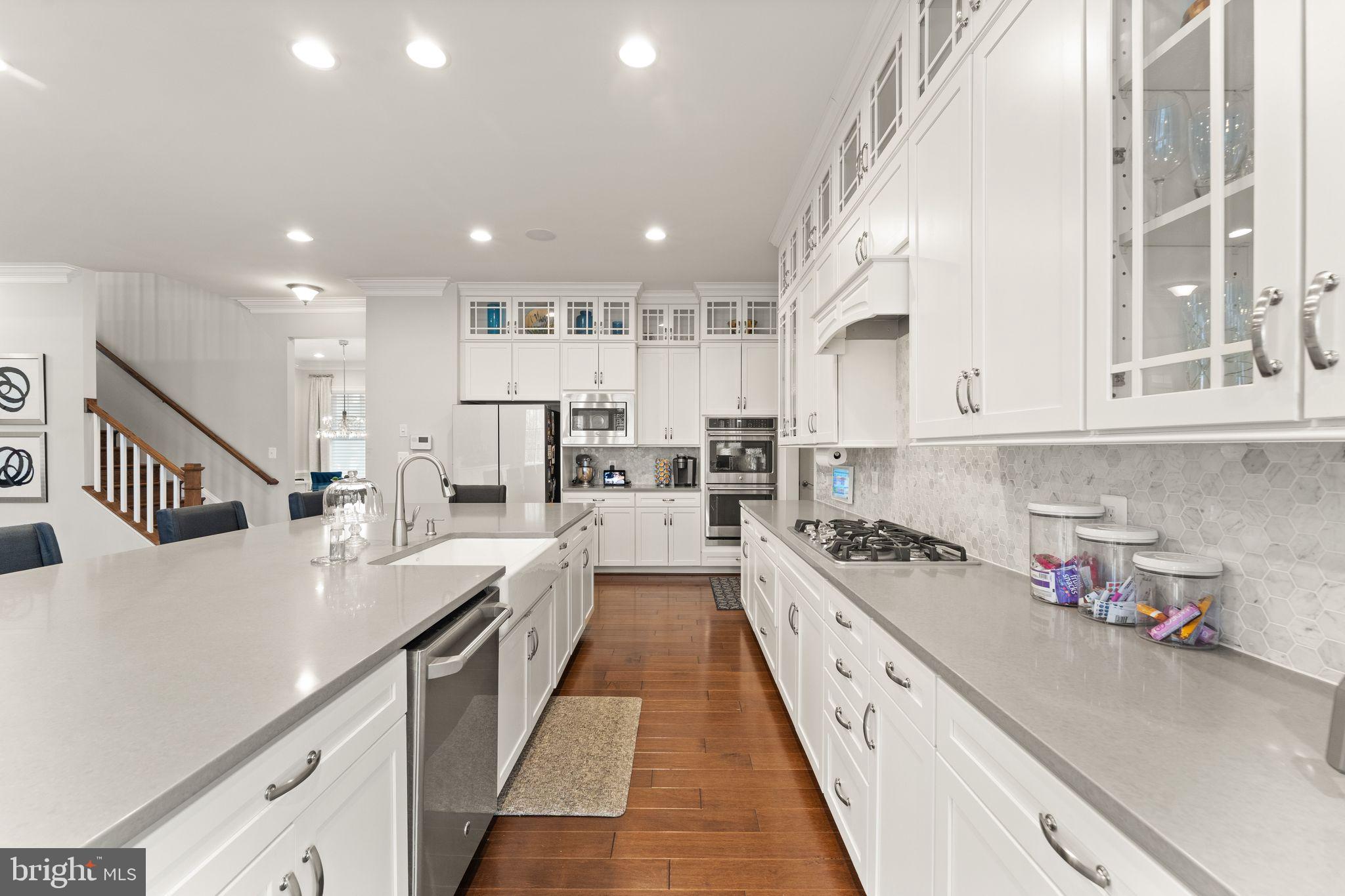 41865 Paddock Gate Place Ashburn, VA 20148 - Photo 12 of 99 a large kitchen with stainless steel appliances lots of counter space cabinets and a sink