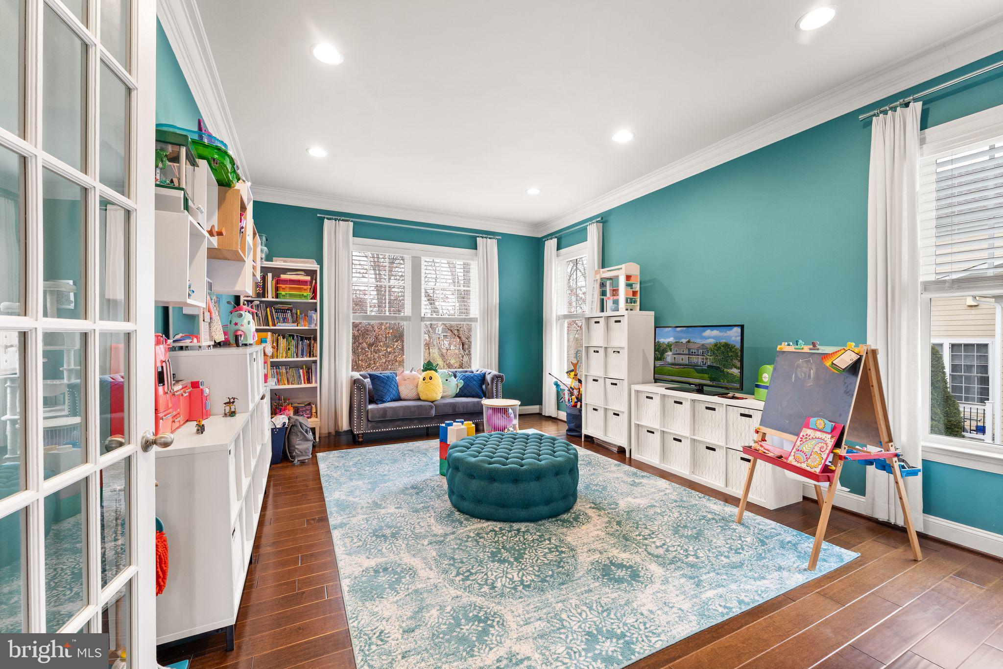 41865 Paddock Gate Place Ashburn, VA 20148 - Photo 30 of 99 a living room with furniture and a flat screen tv