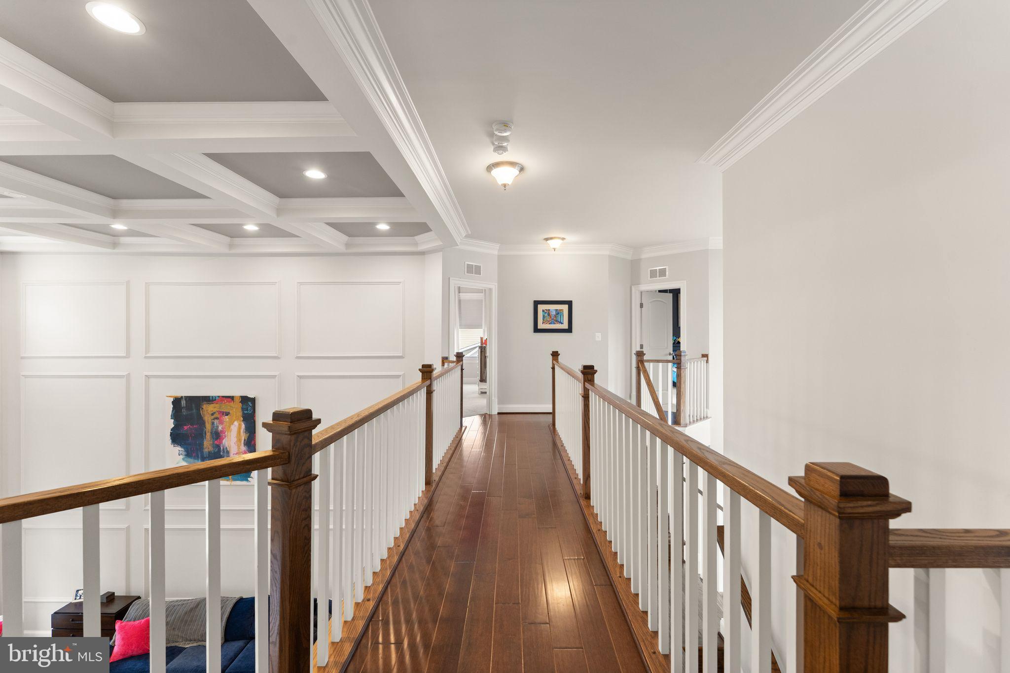 41865 Paddock Gate Place Ashburn, VA 20148 - Photo 33 of 99 a view of a hallway with wooden floor and stairs