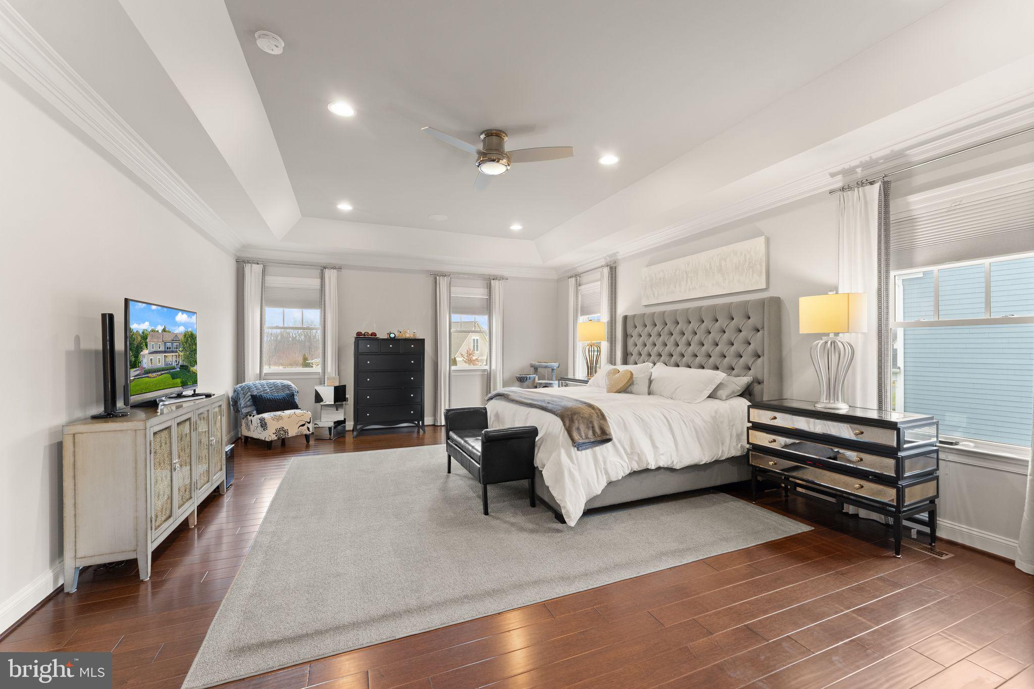 41865 Paddock Gate Place Ashburn, VA 20148 - Photo 36 of 99 a spacious bedroom with a bed couch and a window