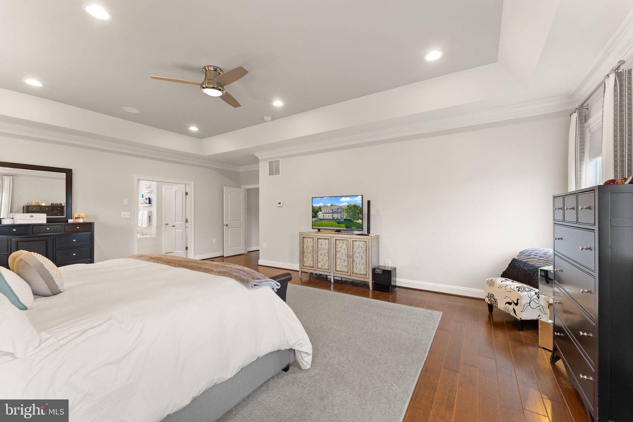 41865 Paddock Gate Place Ashburn, VA 20148 - Photo 39 of 99 a spacious bedroom with a bed and a couch