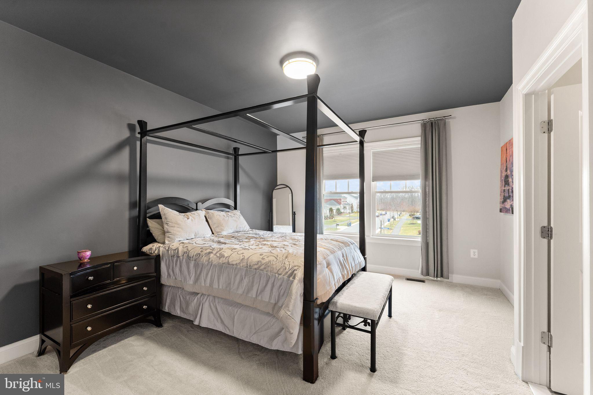 41865 Paddock Gate Place Ashburn, VA 20148 - Photo 45 of 99 a bedroom with a bed window and lamp