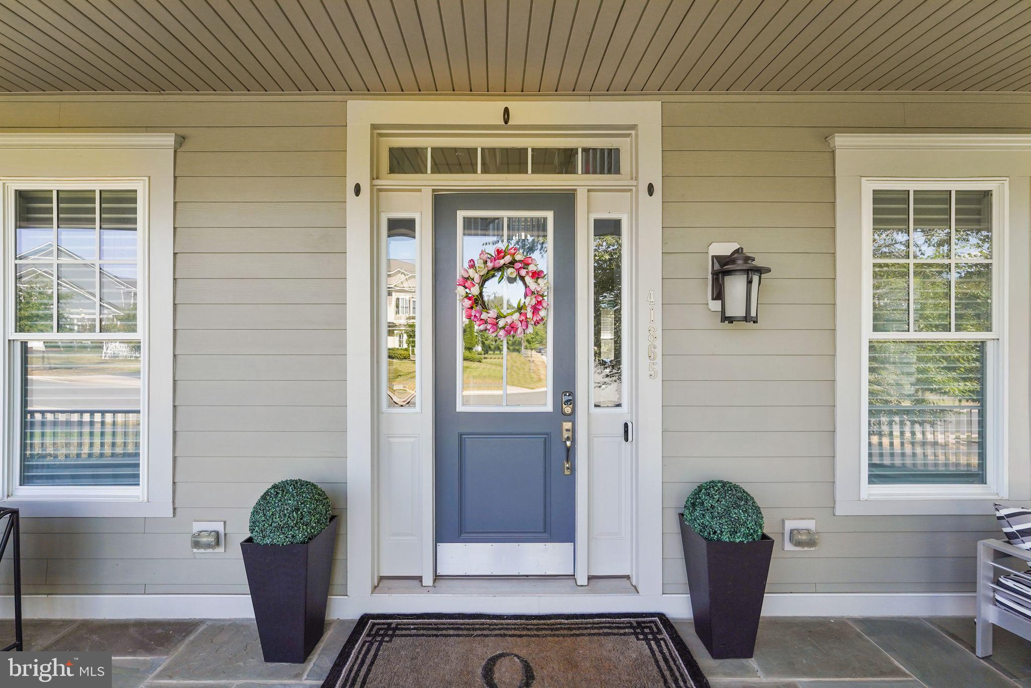 41865 Paddock Gate Place Ashburn, VA 20148 - Photo 5 of 99 a front view of a house with potted plants