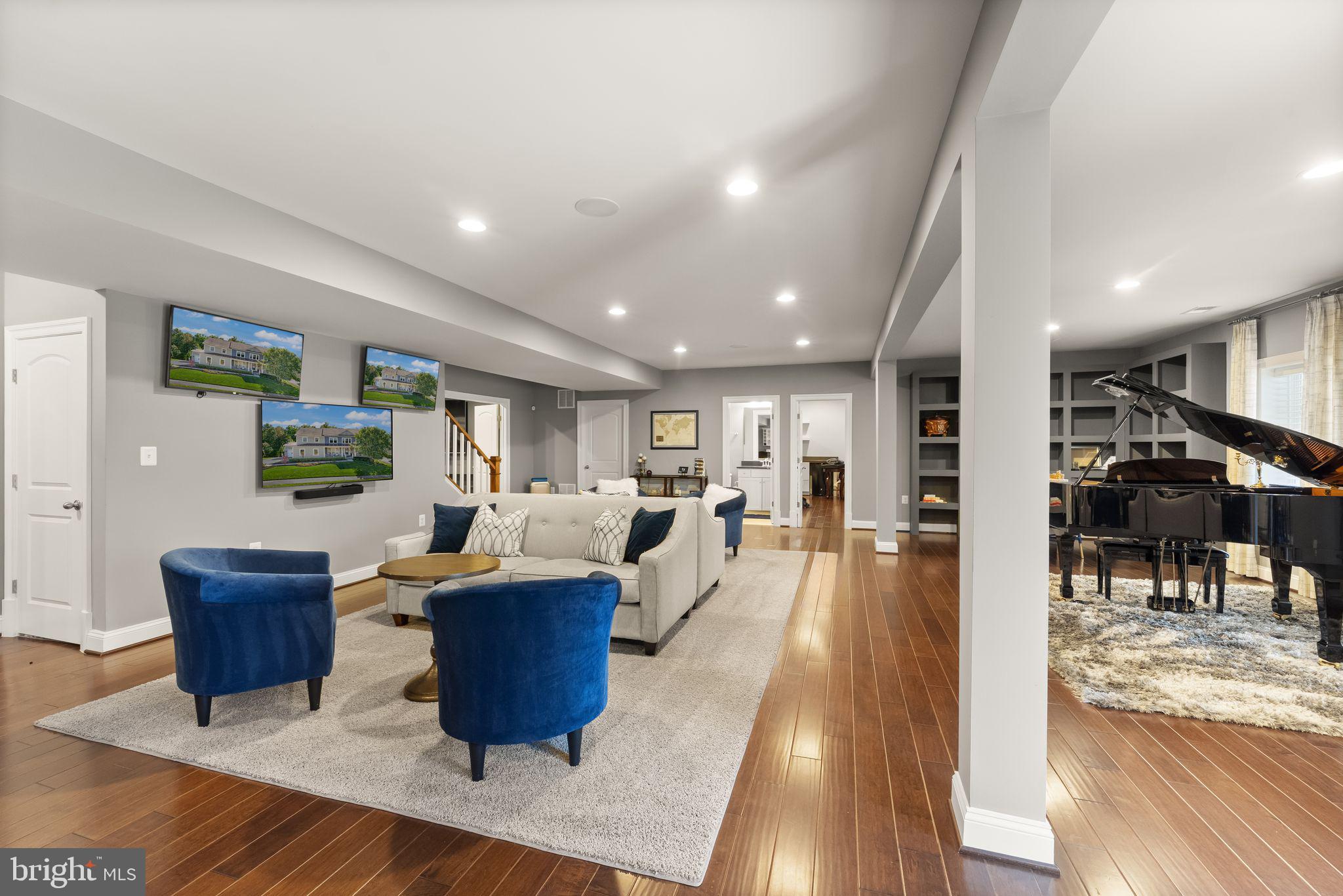 41865 Paddock Gate Place Ashburn, VA 20148 - Photo 56 of 99 a living room with furniture and a wooden floor