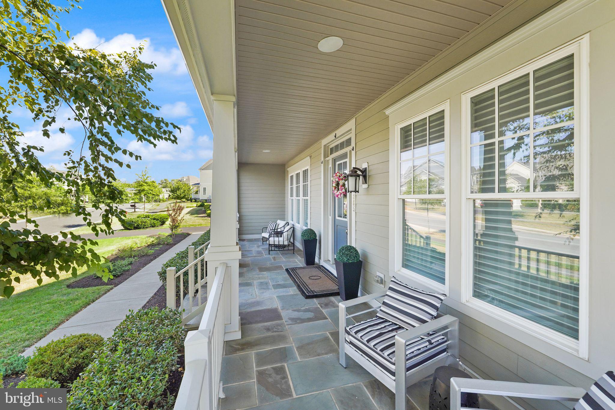41865 Paddock Gate Place Ashburn, VA 20148 - Photo 6 of 99 a balcony with chairs and with potted plants