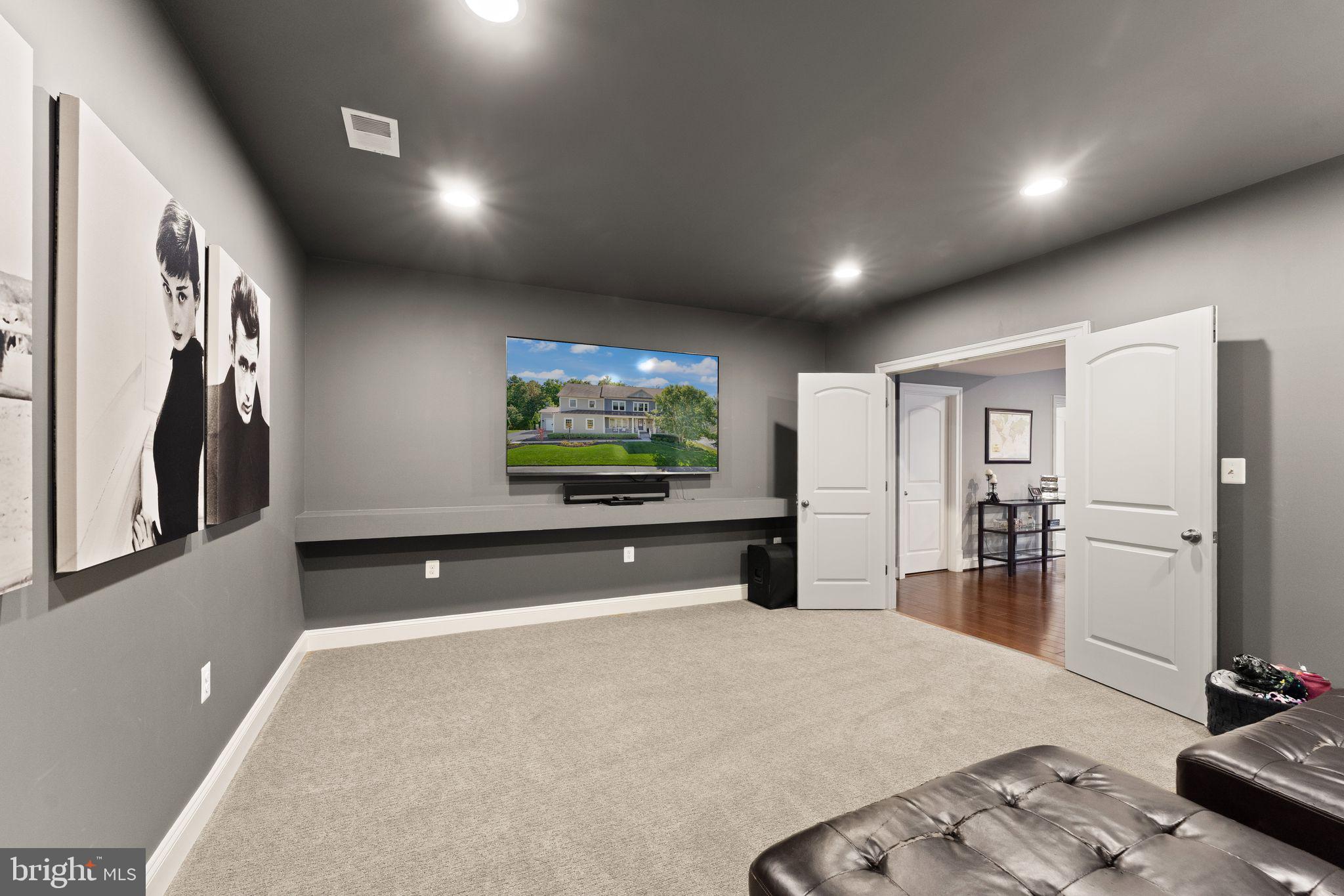 41865 Paddock Gate Place Ashburn, VA 20148 - Photo 68 of 99 a living room with furniture and a flat screen tv