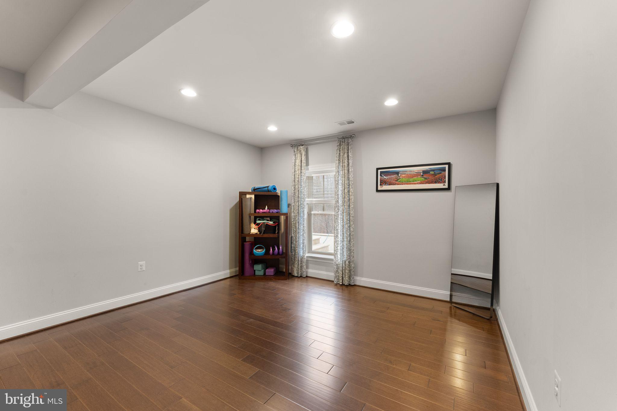 41865 Paddock Gate Place Ashburn, VA 20148 - Photo 69 of 99 a view of an empty room with wooden floor