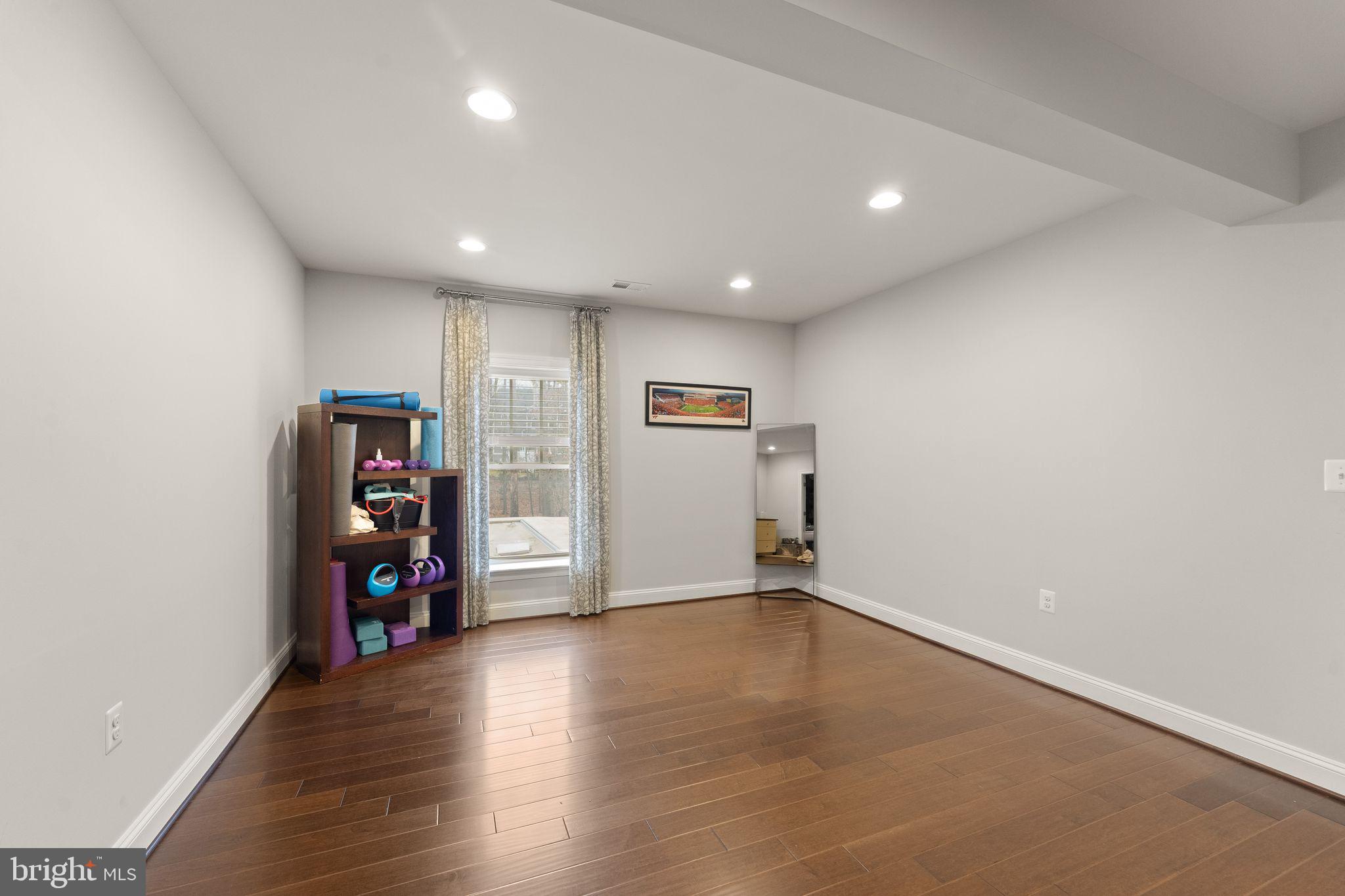 41865 Paddock Gate Place Ashburn, VA 20148 - Photo 70 of 99 an empty room with wooden floor and closet