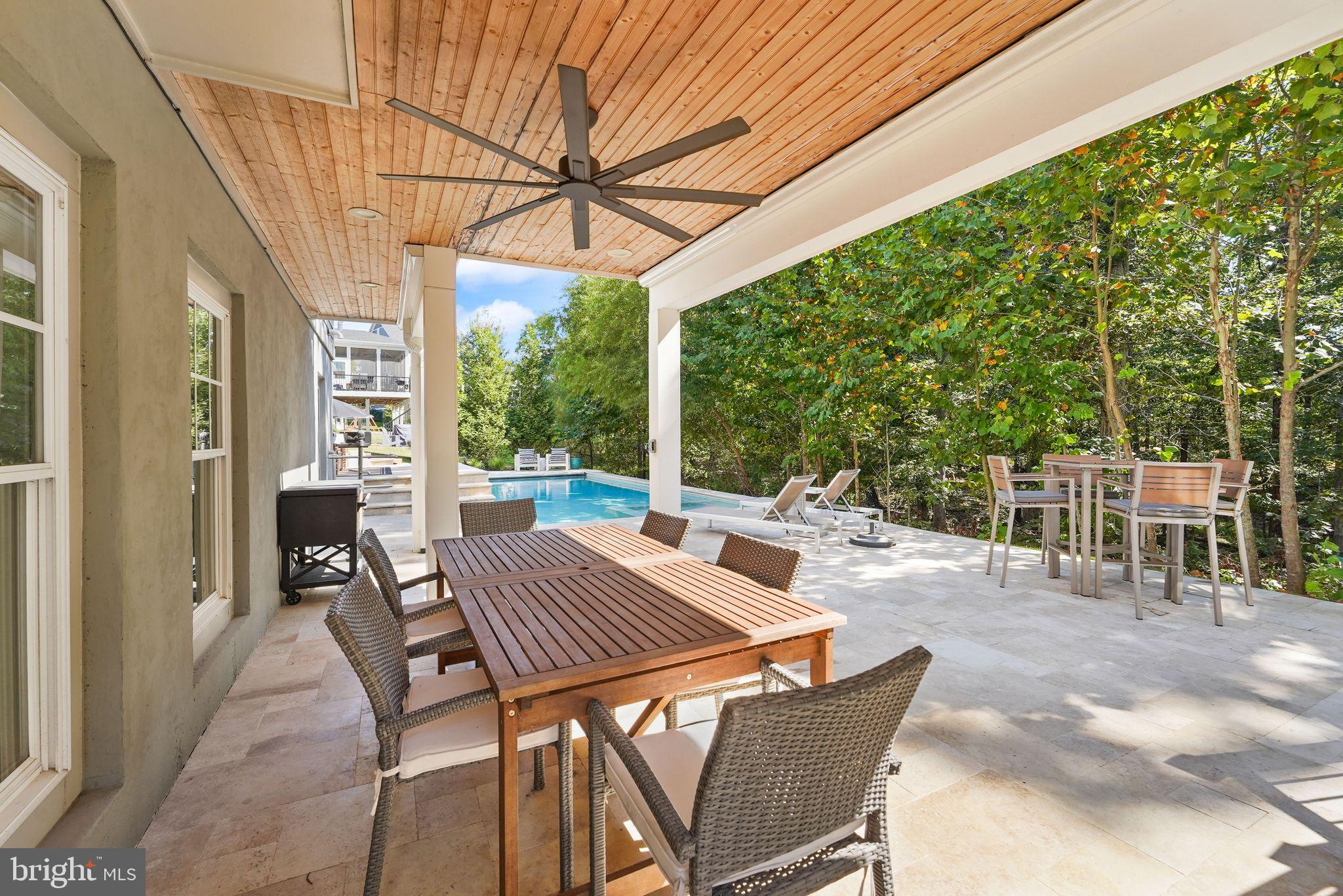 41865 Paddock Gate Place Ashburn, VA 20148 - Photo 81 of 99 a view of a patio with a table chairs and a backyard