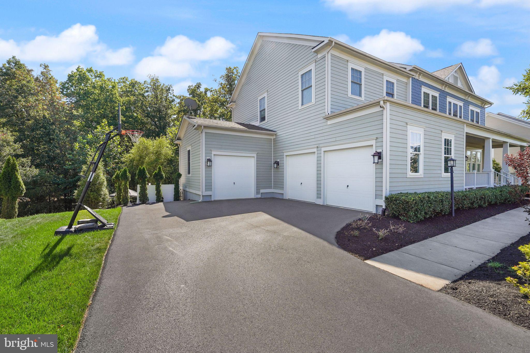 41865 Paddock Gate Place Ashburn, VA 20148 - Photo 91 of 99 a front view of a house with a yard and garage