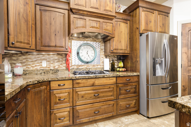 2005 West 450 S Circle St. George, UT 84770 - Photo 16 of 57 Kitchen featuring custom wood cabinetry with varied door styles, granite countertops, and a tile backsplash