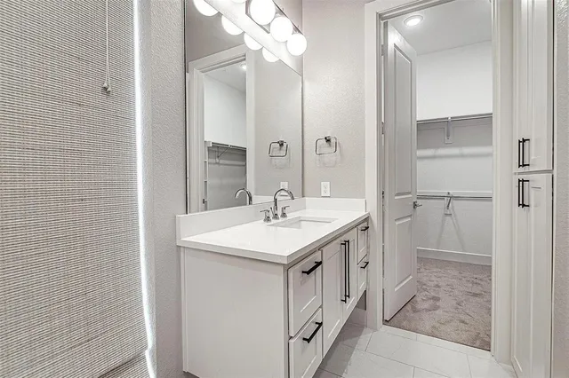 a bathroom with a sink a mirror and a shower