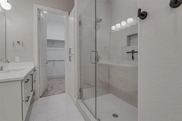 a bathroom with a shower sink and mirror