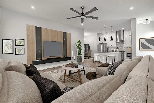 a living room with furniture and a flat screen tv