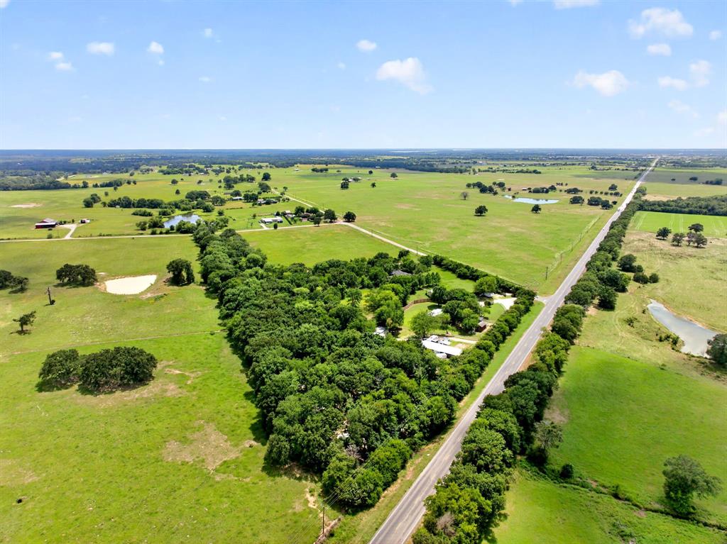 111 County Road 2806 Mabank, TX 75147 - Photo 28 of 34 Expansive rural property featuring a paved road frontage, mature tree lines, multiple residential structures, and various ponds