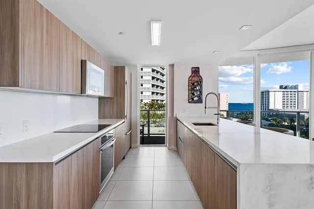 a large white kitchen with a large window
