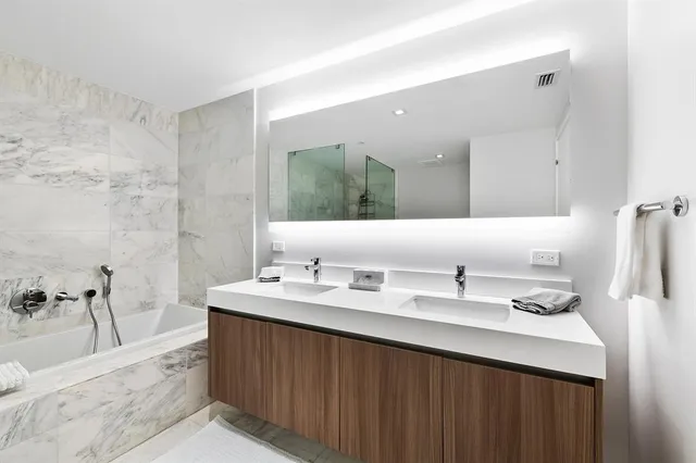 a bathroom with a sink double vanity and a mirror