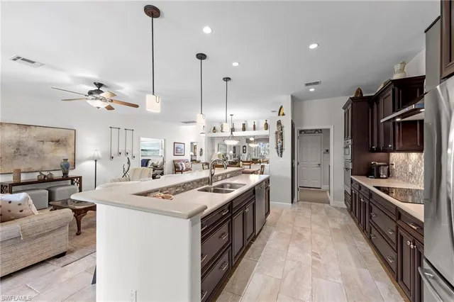 a kitchen with stainless steel appliances granite countertop a stove oven and a refrigerator