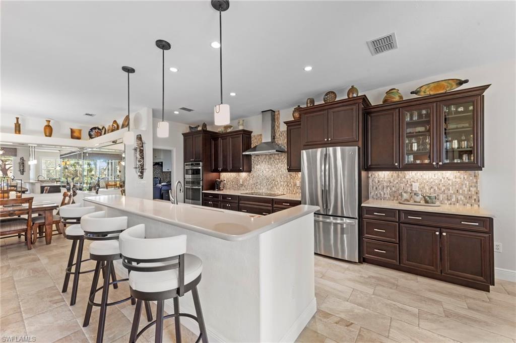 20741 Rivers Ford Estero, FL 33928 - Photo 12 of 50 a kitchen with stainless steel appliances granite countertop a refrigerator and a stove