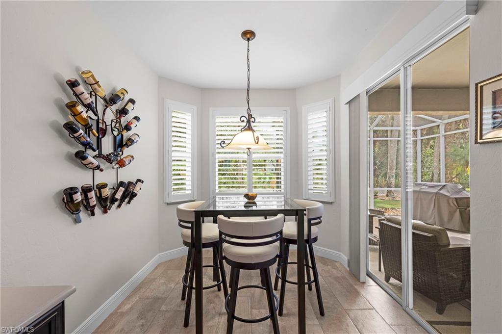 20741 Rivers Ford Estero, FL 33928 - Photo 13 of 50 a dining room with furniture a chandelier and wooden floor