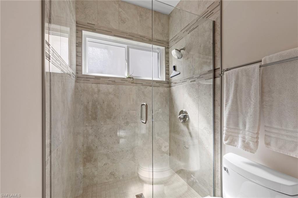 20741 Rivers Ford Estero, FL 33928 - Photo 19 of 50 a bathroom with a glass shower door