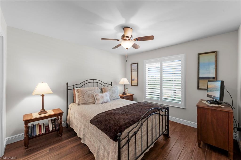 20741 Rivers Ford Estero, FL 33928 - Photo 20 of 50 a bedroom with a bed and a chandelier