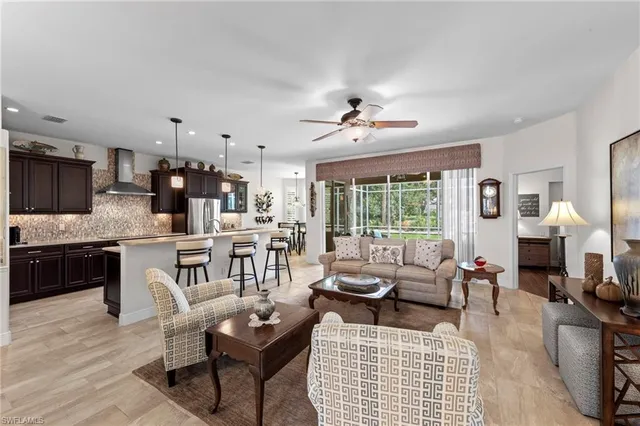 a living room with fireplace furniture and a large window