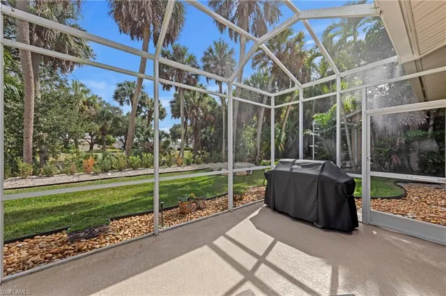 a view of a garden with a couch and wooden fence