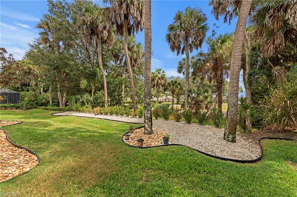 20741 Rivers Ford Estero, FL 33928 - Photo 30 of 50 a view of a garden with tall trees