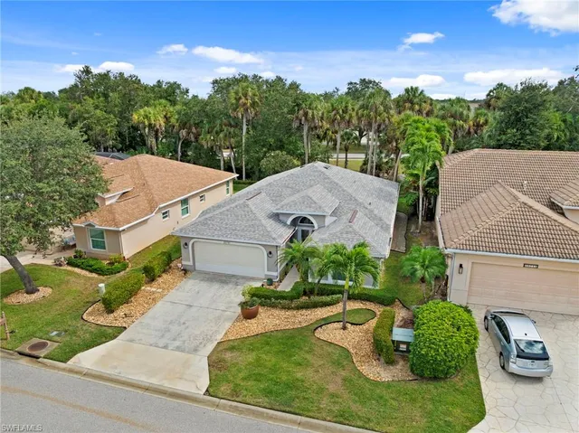 an aerial view of a house with garden space and street view