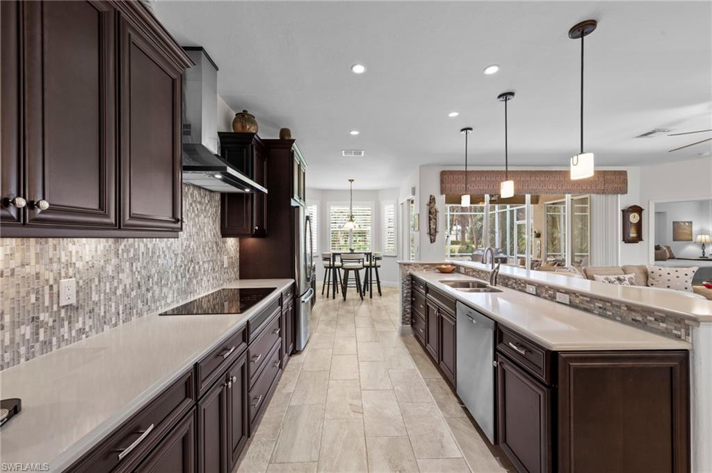 20741 Rivers Ford Estero, FL 33928 - Photo 10 of 50 a kitchen with stainless steel appliances granite countertop a sink a stove and a wooden floors