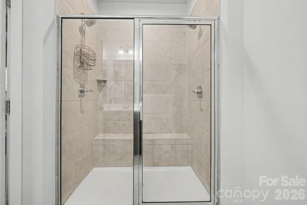 a bathroom with a glass shower door